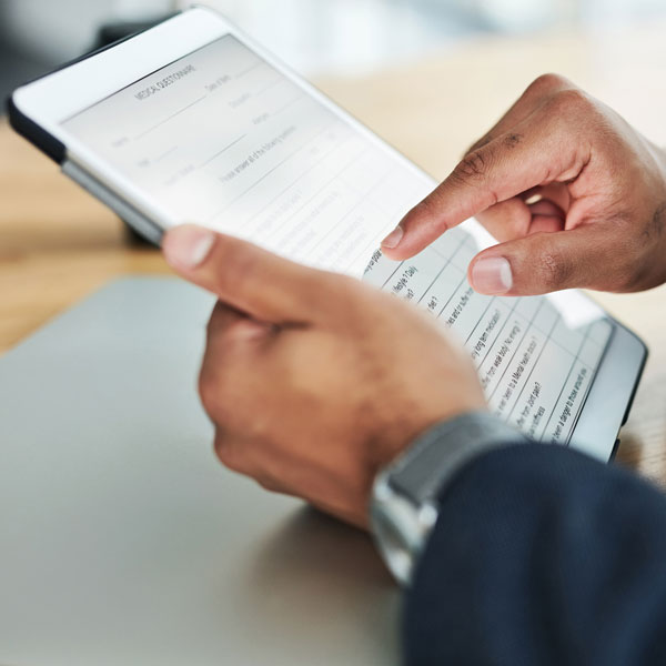 forms Person conveniently filling out new patient forms online, highlighting the ease and flexibility of our digital form process