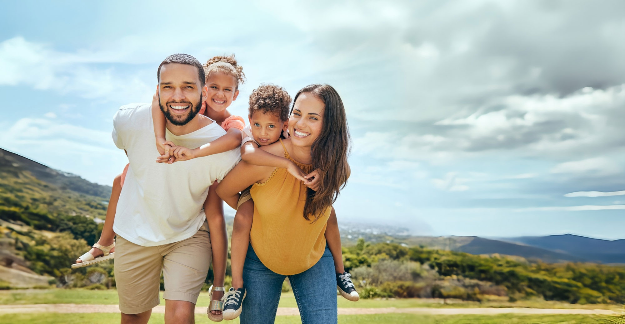 Smiling family enjoying time outdoors, representing happy confident smiles from orthodontic care.