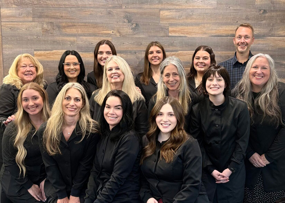 Smiling Lowe orthodontic team standing together in the office, ready to welcome patients with expert care.
