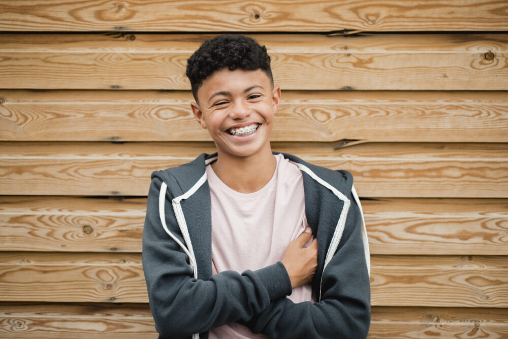 Teenage Boy with braces. Teenager wearing braces and smiling with confidence, showing how orthodontic treatment supports oral health while boosting self-esteem.